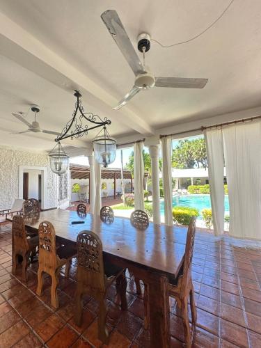 a dining room with a wooden table and chairs at Glamorous Getaway PM in Malindi
