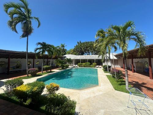 a swimming pool in a yard with palm trees at Glamorous Getaway PM in Malindi