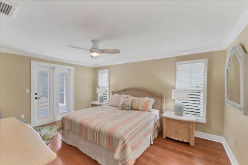 a bedroom with a bed and two windows at GRH14784 - Charlotte County - 4 Bed 2 Baths House in Punta Gorda Isles