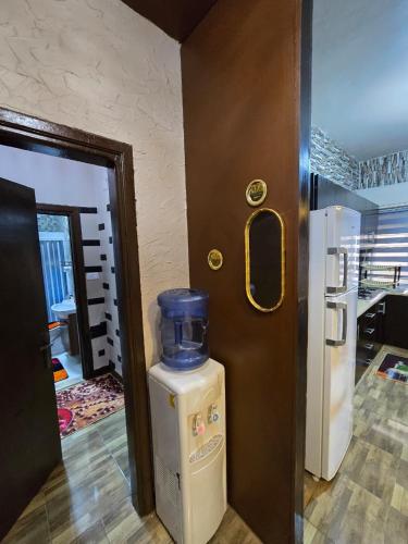 a door to a room with a refrigerator next to a kitchen at Deluxe Furnished Studio Jubaiha in Amman