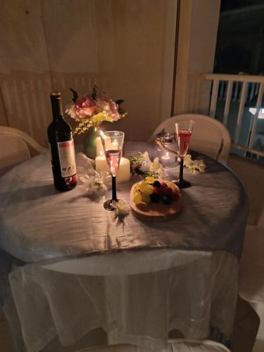 a table with a bottle of wine and a cake and glasses at BRISA DEL MAR en primera línea in Torres-Torres