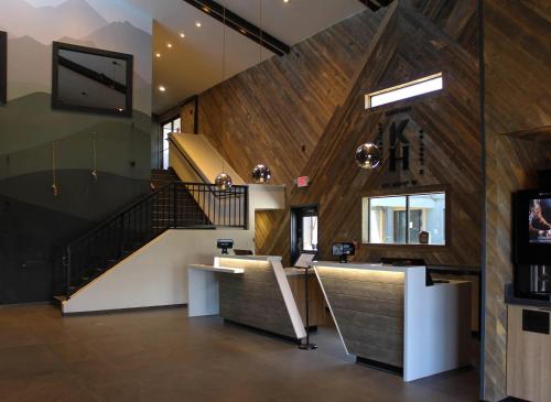a lobby with a staircase and a bar in a building at The Kendrick Hotel, an Ascend Collection Hotel in Flagstaff