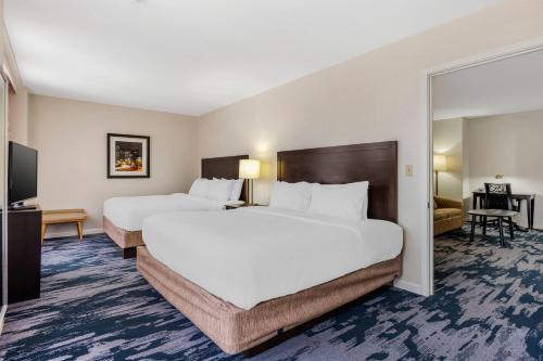 a hotel room with two beds and a flat screen tv at The Connally Hotel Downtown Atlanta, an Ascend Collection Hotel in Atlanta