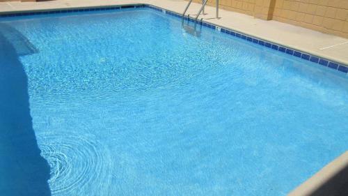 a large pool of blue water in a building at Rodeway Inn Yuma Downtown in Yuma