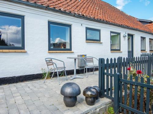 a patio with chairs and a table in front of a house at Enchanting Cottage in Oksbol Oasis-By Traum in Nordborg