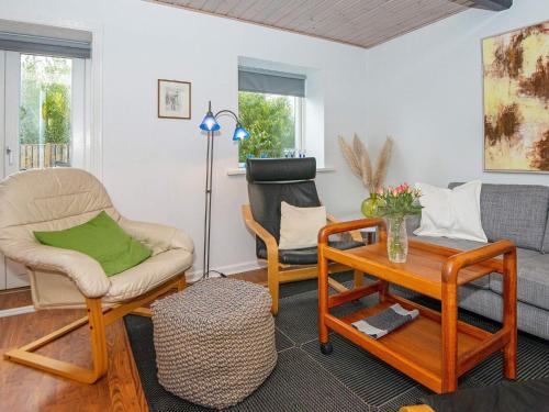a living room with two chairs and a table at Enchanting Cottage in Oksbol Oasis-By Traum in Nordborg
