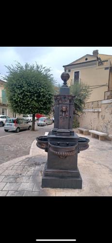 a fountain in the middle of a street at Residence Della Corte in Tocco da Casauria