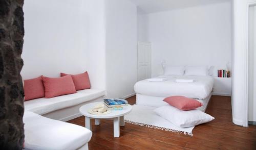 a living room with two beds and a couch at Finikia Memories Hotel in Oia