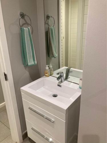 a bathroom with a white sink and a mirror at Pebble Beach 204 in Sibaya