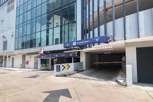 an entrance to a building with a sign on it at ❈ Tropicana 218 by ALV Suites ❈ in George Town