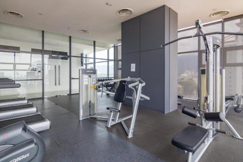 a gym with two treadmills and cardio equipment in a building at ❈ Tropicana 218 by ALV Suites ❈ in George Town