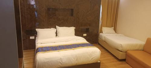 Ein Bett oder Betten in einem Zimmer der Unterkunft Heranya Taleju