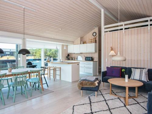 a living room and kitchen with a table and chairs at 6 person holiday home in Fanø-By Traum in Fanø