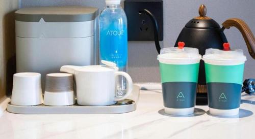 a counter with cups and a coffee maker on it at Atour Hotel Weihai Shidao in Dongshan