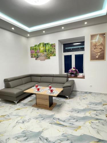 a living room with a couch and a coffee table at PENZION Hamburk in Beroun