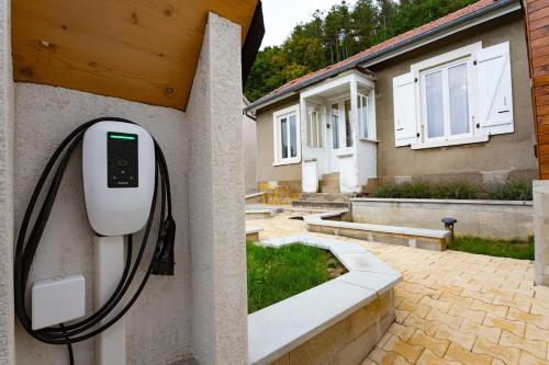 a home with a pay phone attached to a wall at Gîtes de l'Orée du Bois - Torpes in Torpes