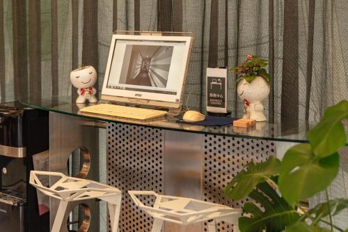 a computer sitting on top of a glass table at Hotel G7 Taipei in Taipei