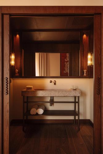 a bathroom with a sink and a mirror at Palacio De Godoy Caceres, Curio Collection By Hilton in Cáceres