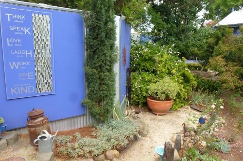 a garden with a blue door and some plants at The Retreat at Froog Moore Park in Tamworth