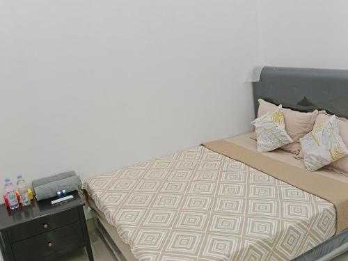 a small bedroom with a bed with a desk at Damar Tree Resort Krui in Krui