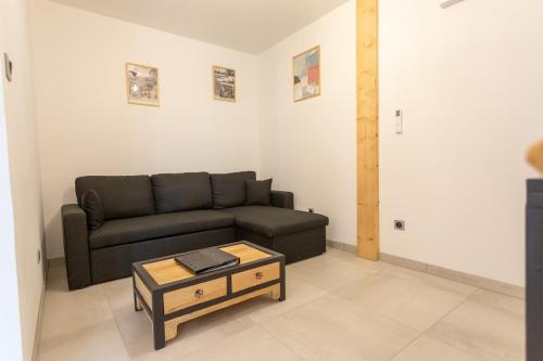 a living room with a couch and a coffee table at Gîtes de l'Orée du Bois - Torpes in Torpes