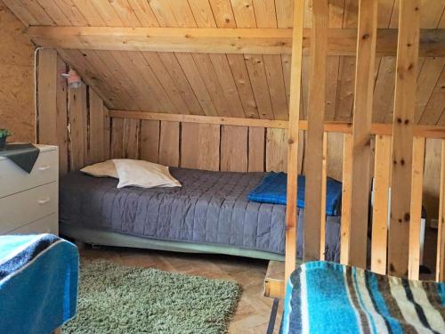 a bedroom with a bed in a wooden cabin at 5 person holiday home in TINGSRYD-By Traum in Tingsryd
