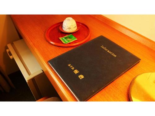 a black book on a desk with a red plate at Hotel Itakura - Vacation STAY 70076v in Fukushima