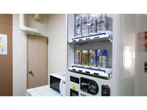 a refrigerator with cans of soda in a kitchen at Hotel Itakura - Vacation STAY 70085v in Fukushima