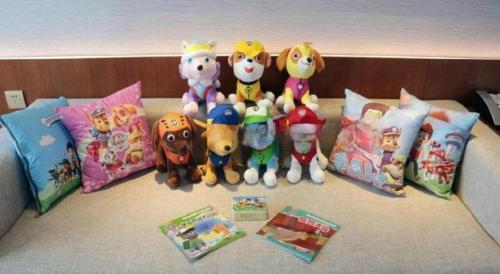 a group of stuffed animals sitting on a bed at Deacon House Wuxi in Wuxi