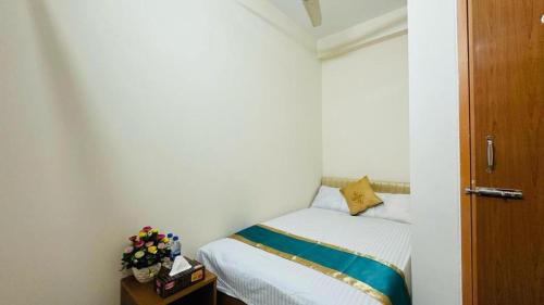a small bedroom with a bed in a room at Hotel Tulip Residence in Dhaka