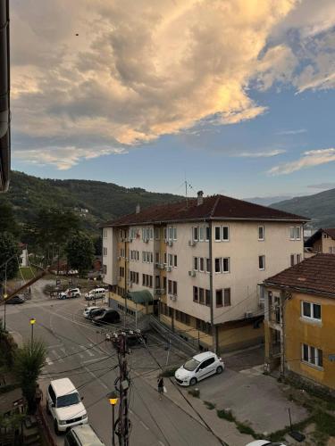 a city with cars parked in a parking lot at BPMNEdailyrent in Bijelo Polje