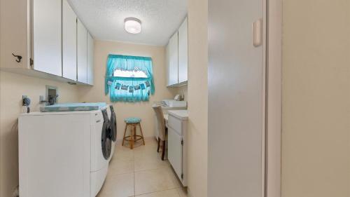 a kitchen with a washer and dryer in a room at GRH10327 - Charlotte Harbor Area - 3 Bed 2 Baths Villa in Punta Gorda Isles