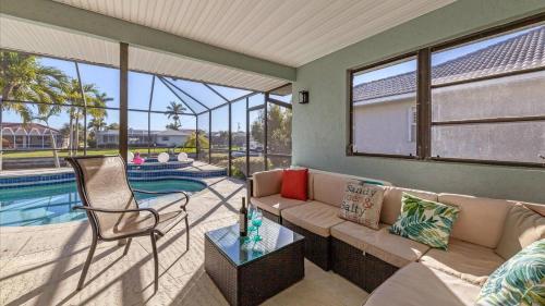 a living room with a couch and a chair and a pool at GRH10327 - Charlotte Harbor Area - 3 Bed 2 Baths Villa in Punta Gorda Isles