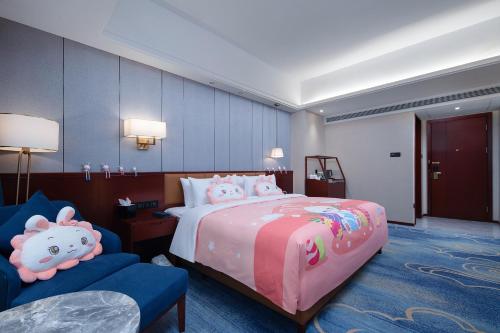 a bedroom with a bed with hello kitty pillows at Grand Sun City Hotel-Located city center Metro Access in Changsha