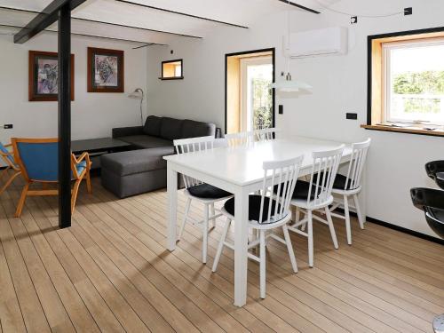 a living room with a white table and chairs at 6 person holiday home in Hadsund in Hadsund