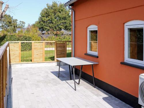 a table on a patio next to a building at 6 person holiday home in Hadsund in Hadsund