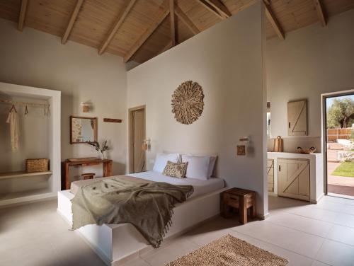a bedroom with a white bed and a window at Conte Maris V in Tragaki