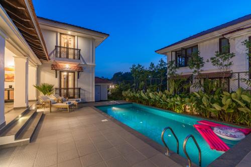 a swimming pool in the backyard of a house at Villa Lumi, Villas By Noor in Aldona