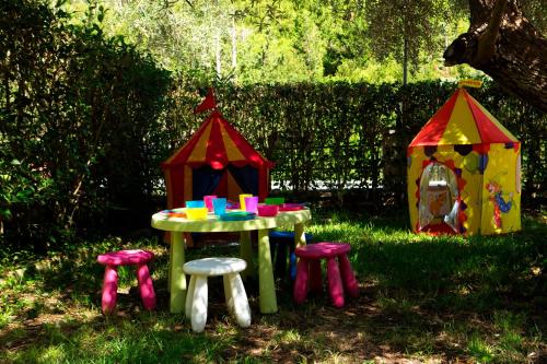 a pretend play table and stools in the grass at Evridiki's Villas in Agios Nikitas