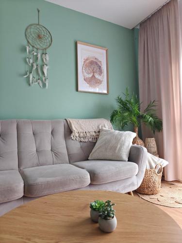 a living room with a couch and a table at Apartament w sercu Żor in Żory