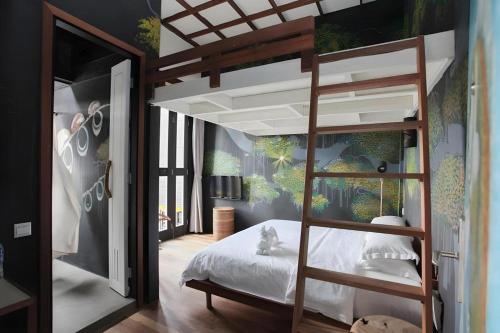a bedroom with a bunk bed with white sheets at The Happy 8 Retreat @ Kuala Sepetang in Kampung Sepetang