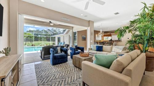 a living room with furniture and a pool at GRH11408 - Charlotte Harbor Area - 3 Bed 3 Baths Villa in Rotonda