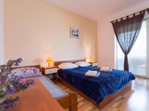 a bedroom with two beds and a window at Apartment in Senj near the Sea & Pool in Senj