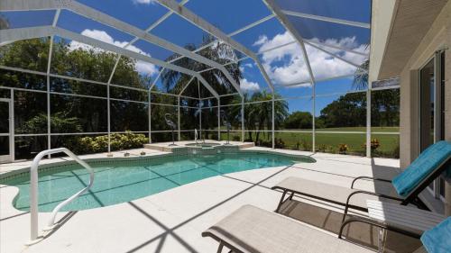 an indoor swimming pool in a house with a glass ceiling at GRH11408 - Charlotte Harbor Area - 3 Bed 3 Baths Villa in Rotonda