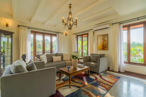 a living room with a couch and a table at Villa Lumi, Villas By Noor in Aldona