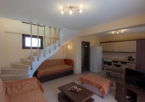 a living room with a staircase and a living room at Ianthi Maisonettes in Nea Roda