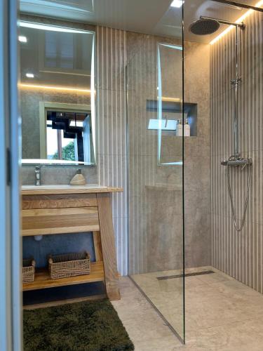 a bathroom with a glass shower and a sink at Вирій in Slavske
