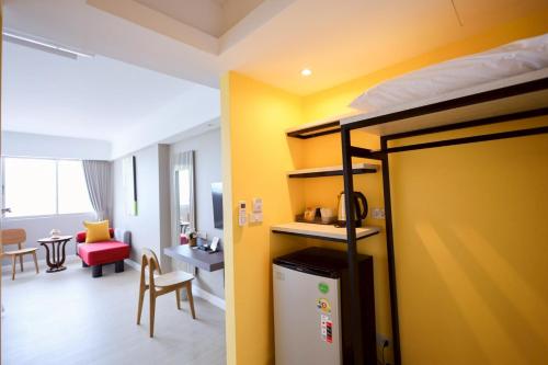 a room with a bunk bed and a living room at Hua Hin Grand Hotel and Plaza - SHA Extra Plus in Hua Hin