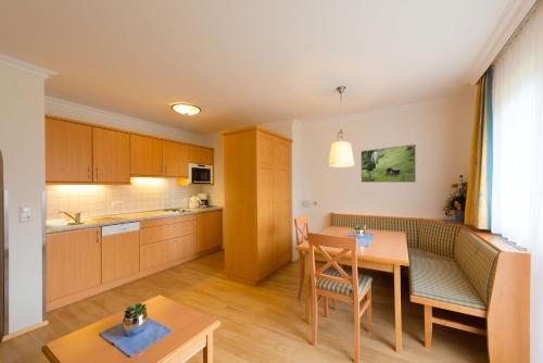 a kitchen with a table and a dining room at Landhaus Huber in Grossarl