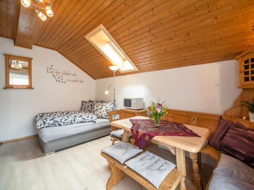a living room with a table and a couch at Apartment in Tröpolach near Nassfeld in Tröpolach